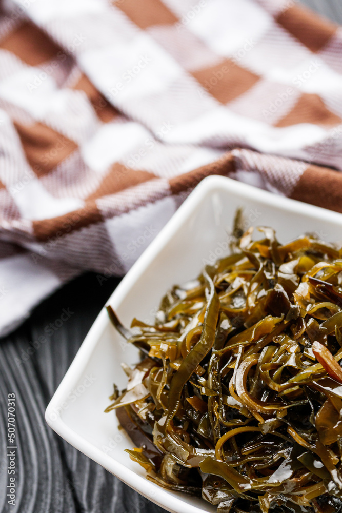seaweed salad on a black wooden rustic background
