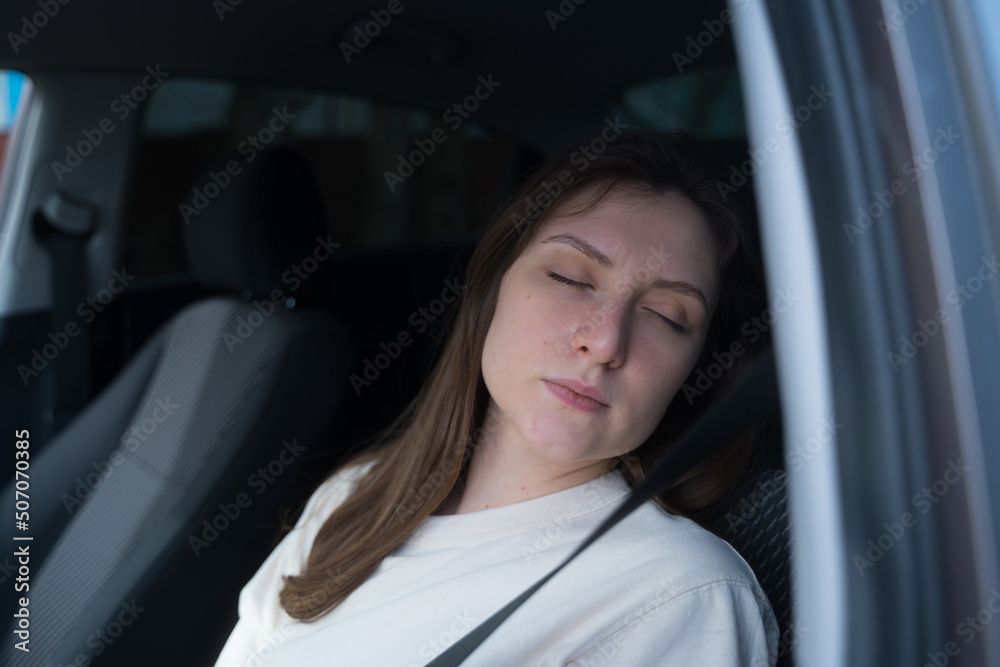 The female driver is sleeping in the car. Chronic fatigue, work in a taxi