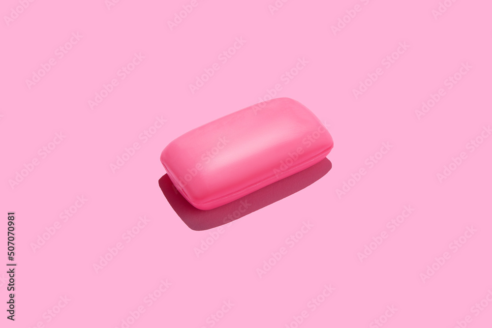 Pink soap bar in center of pink background Pink soap bar in center of pink background