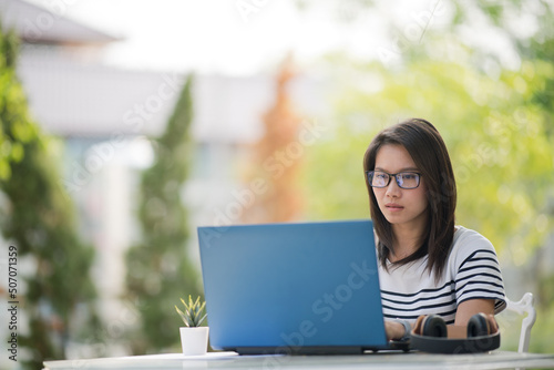 woman looking at laptop computer, thinking new project 