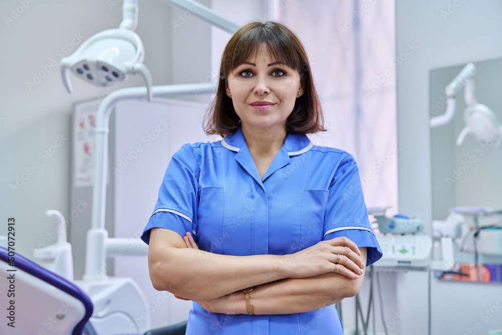 Portrait of smiling nurse looking at camera in dentistry. Portrait of smiling nurse looking at camera in dentistry.