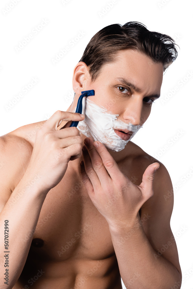 shirtless man with bare chest looking at camera and shaving isolated on white.