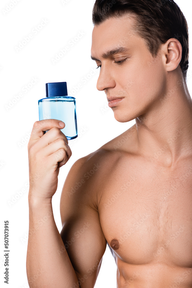 brunette man with bare chest holding after shave lotion isolated on white. brunette man with bare chest holding after shave lotion isolated on white.