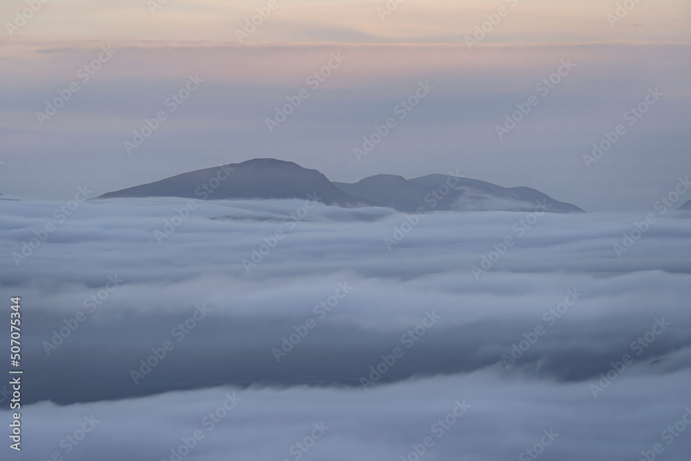 Snowdonia mountains above a spectacular cloud inversion in Wales UK Snowdonia mountains above a spectacular cloud inversion in Wales UK
