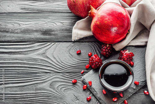 fresh pomegranate sauce narsharab on a black wooden rustic background photo