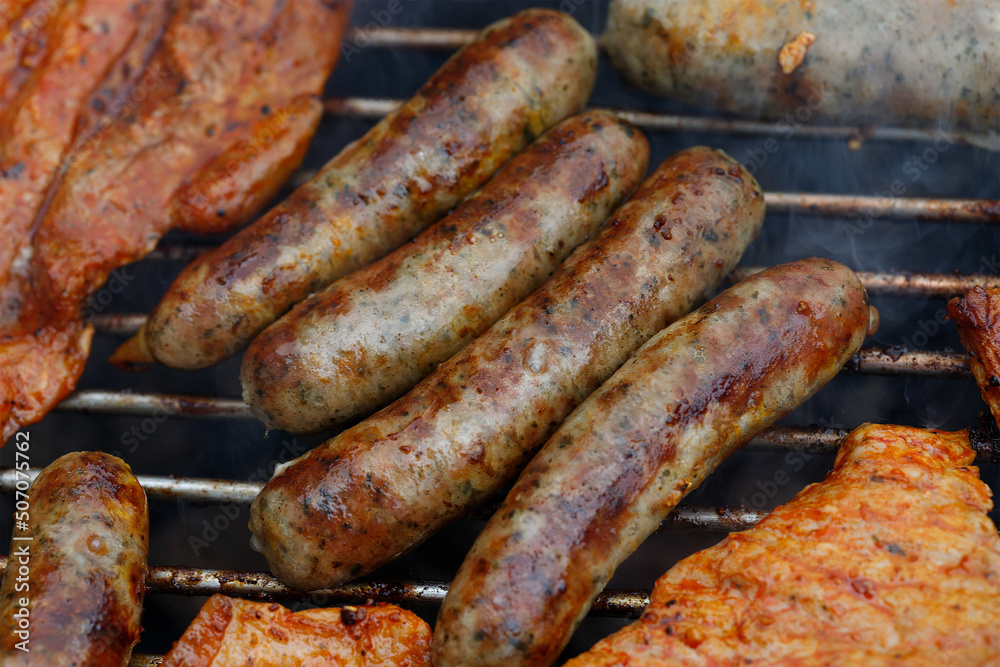Grilled sausages on a grill. Barbecue food, grill, barbecue. Summer party food. top view.