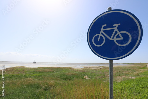 Road sign indicating that it is only a cycle path with view on the Wadden Sea and the gorgeous coastline of the Dutch Wadden Isle of Schiermonnikoog.