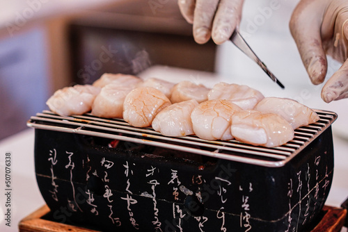 Focus on chef's hand cooking Hotate steak or scallop steak