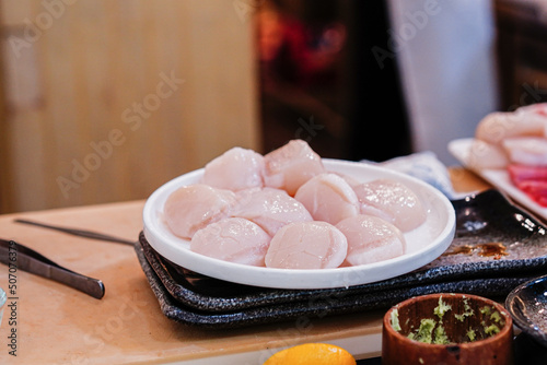 Focus on the fresh Hotate scallop in the sushi bar.