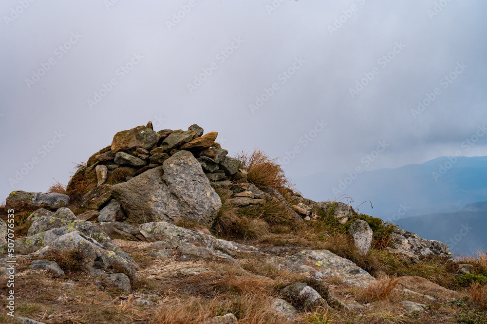 mountain top made of stones, rocky mountains with autumn landscape.