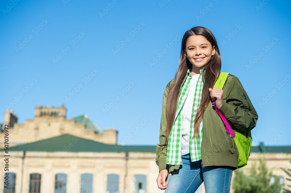 positive kid with school bag outdoor with copy space. back to school