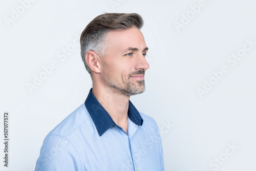 cheerful mature businessman in office shirt on grey background