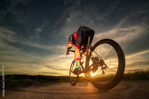Fototapeta Naklejka Na Ścianę i Meble -  Male cyclist Practicing for a bicycle sunset time