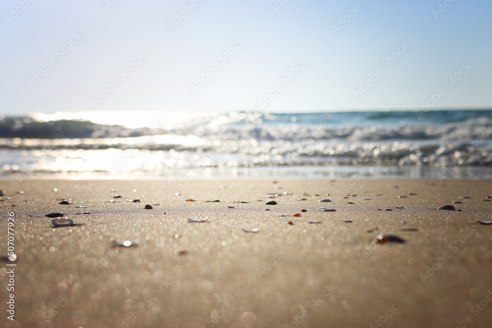Sea waves and warm sunset light, calm and relaxing sandy beach Sea waves and warm sunset light, calm and relaxing sandy beach