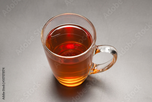 A turkish glass of tea on black background.