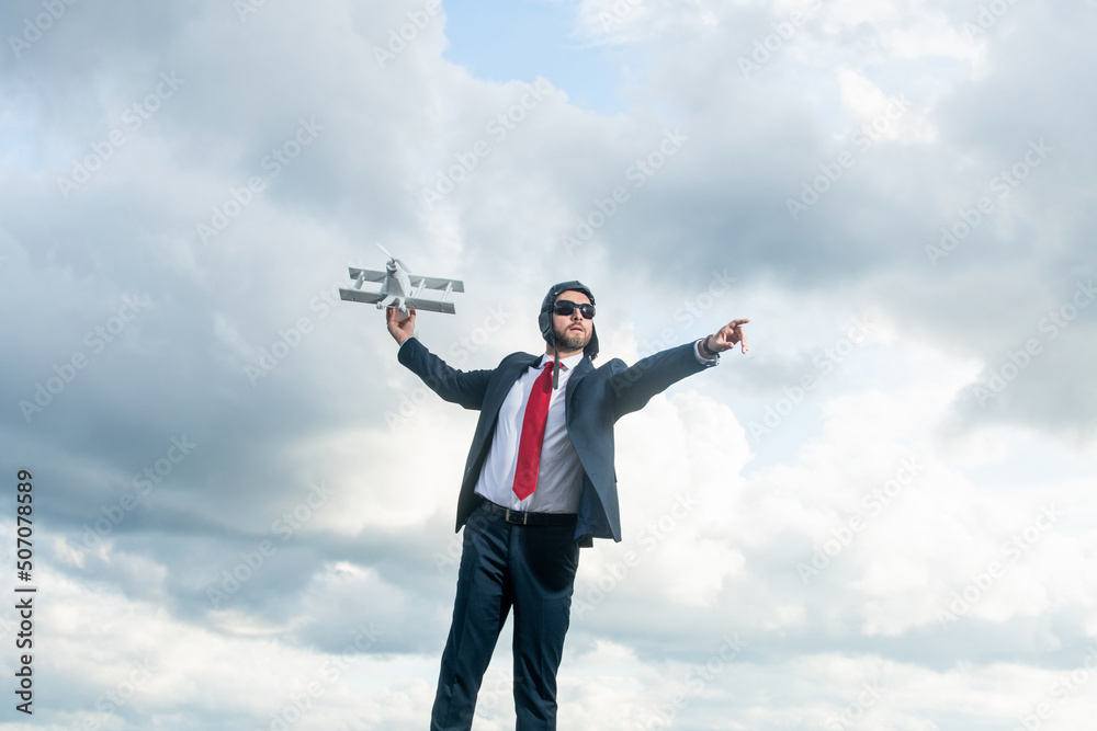 businessman in suit and pilot hat launch plane toy on sky background. leadership businessman in suit and pilot hat launch plane toy on sky background. leadership