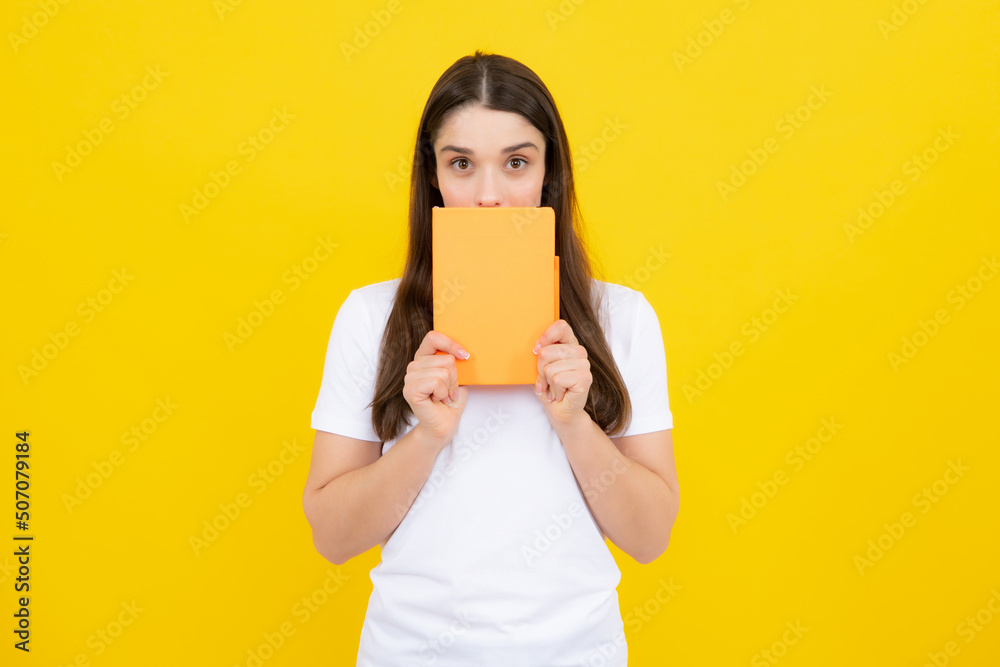 Charming student isolated on yellow color background. Woman high school student hold notebooks. Education in high school university college concept. Charming student isolated on yellow color background. Woman high school student hold notebooks. Education in high school university college concept.