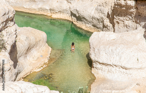 Tiwi, Oman - famous of its vertical cliffs and the green water, Wadi Shab is one of the most beautiful wadi in Oman, and a very popular tourist destination  photo