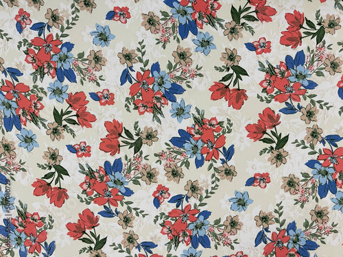 The red and blue floral flowers with leaves pattern on fabric © Zuyu