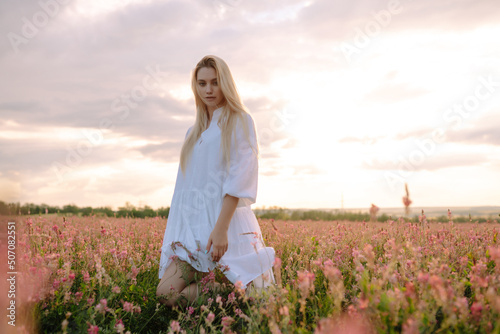 Beautiful woman in the blooming field. Nature, vacation, relax and lifestyle. Summer landscape. © maxbelchenko