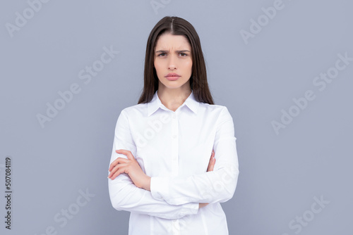 unpleased businesslady in white shirt on grey background, success
