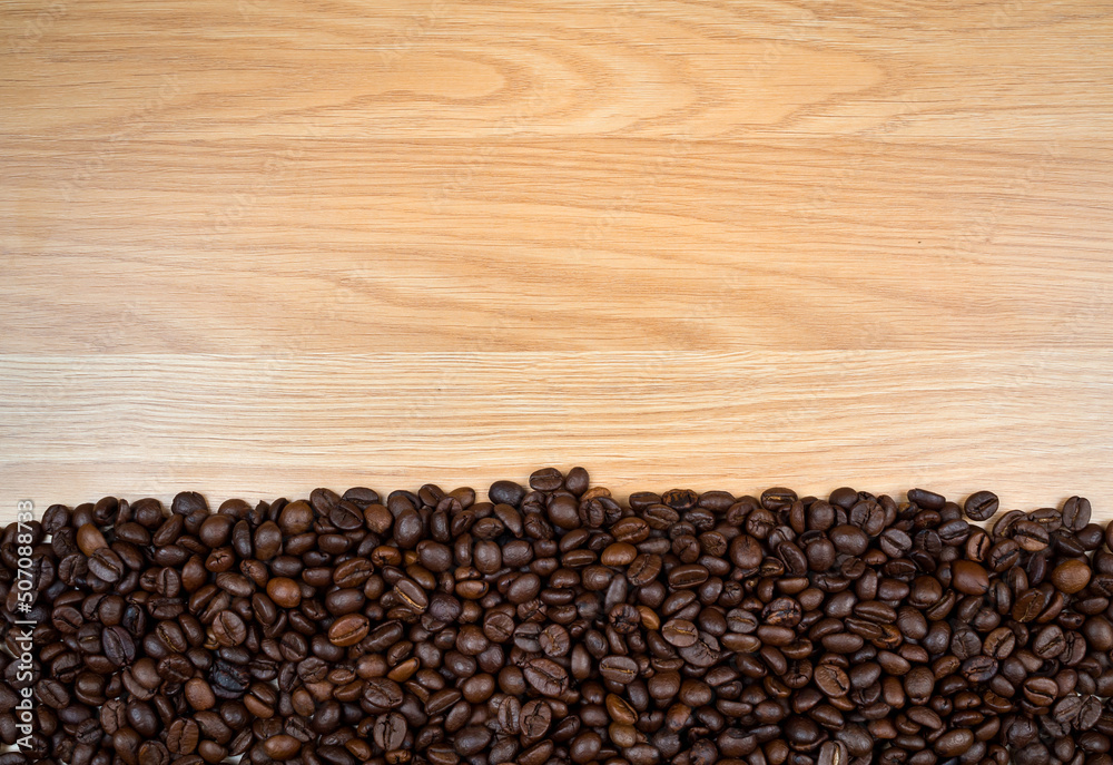 Roasted coffee beans on brown wooden background. copy space Roasted coffee beans on brown wooden background. copy space