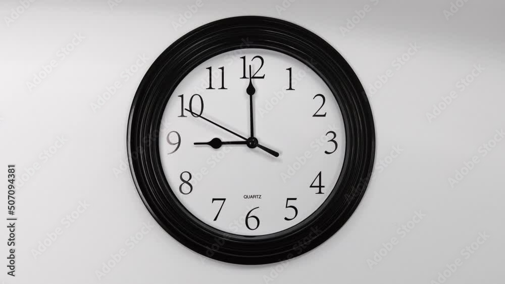 Classic Black Wall Clock With White Background. Black Hands On The Clock. Timelapse. Wall Clock Face Of Time Of 9.00 Am Or Pm. 4k. ProRes.