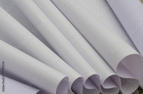 rolls of white flexible fabric. blank fabric sample with fibrous texture. banner material, digital printing industry. stack of paper