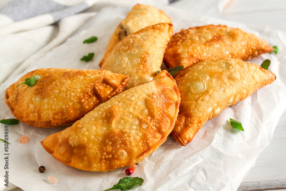 Fried chebureks, close-up, on a light background, no people, Fried chebureks, close-up, on a light background, no people,