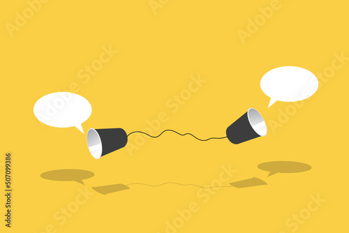 Two black paper cup connect with black rope used for classic phone on yellow background. For old communication system concept. photo