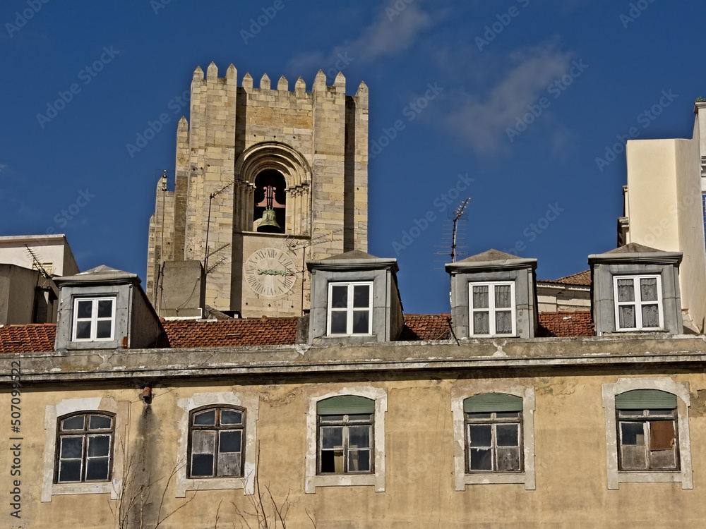 Clock tower of Lisbon cathedral ovr the rooftop of a house in Alfama, Lisbon Clock tower of Lisbon cathedral ovr the rooftop of a house in Alfama, Lisbon
