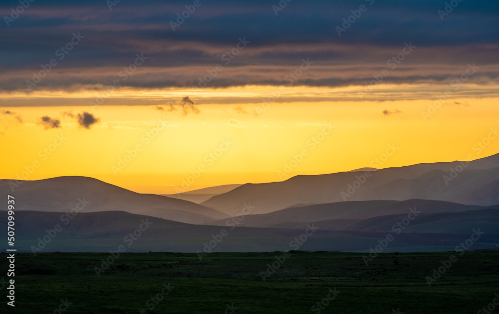 Obraz premium Dramatic sunset in Aksu Zhabagly Reserve. Fairytale evening dark panorama landscape.