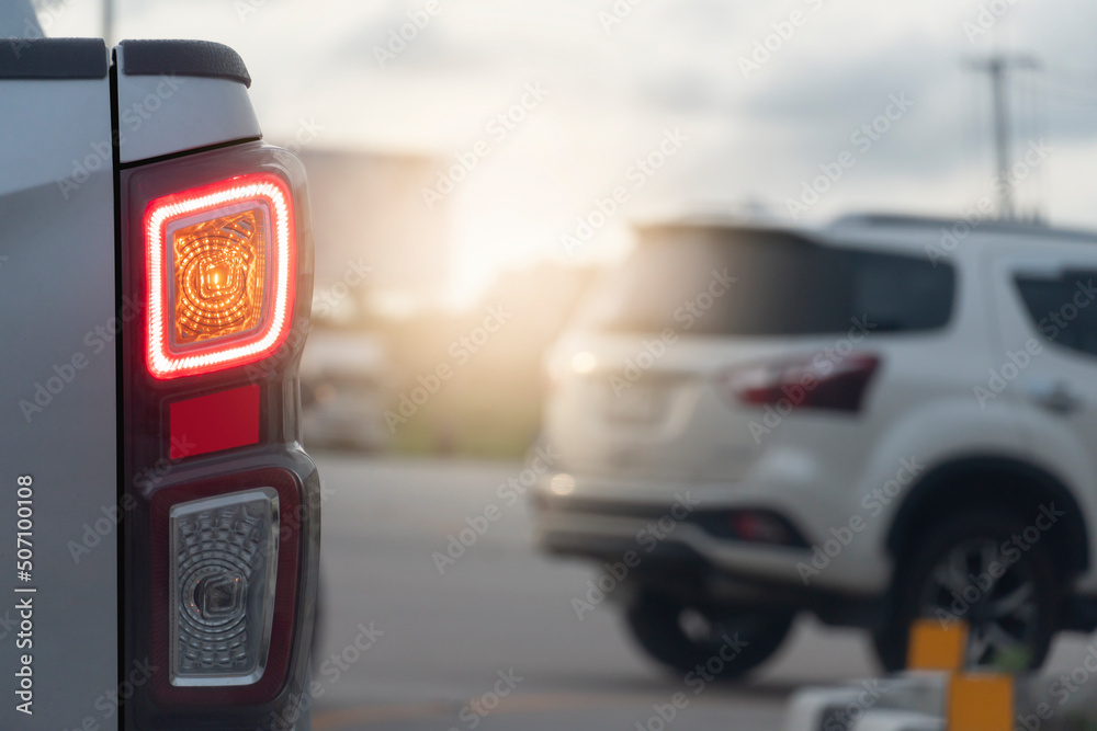 Rear side of pick up car open turn light signal for prepare to u-turn. with blurred of car in front is making a reversal. Rear side of pick up car open turn light signal for prepare to u-turn. with blurred of car in front is making a reversal.