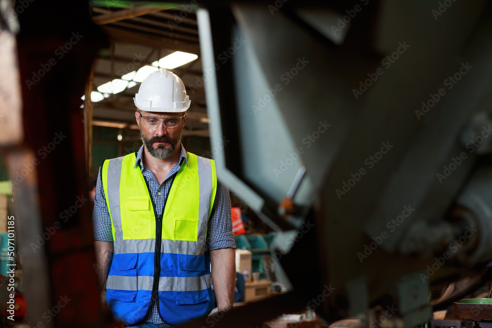 Caucasian male engineer Inspection, control, maintenance, machinery for the production of metal parts in industrial plants Caucasian male engineer Inspection, control, maintenance, machinery for the production of metal parts in industrial plants