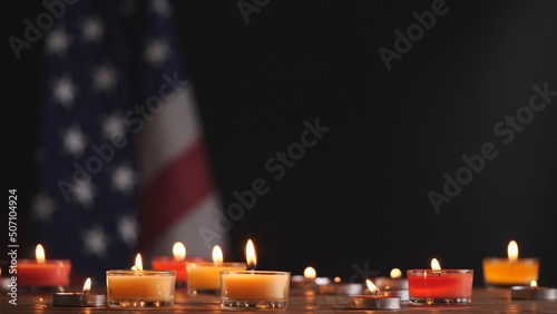 Happy Memorial Day, Man hand lighting memorial candle on American USA flag dark background. Concept of 4th of July, Independence Day, Memorial Day, Veterans Day, Honor, Military, Patriot