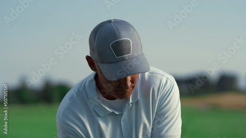 Sport man play golf match game on fairway. Senior player swinging golfing club. photo