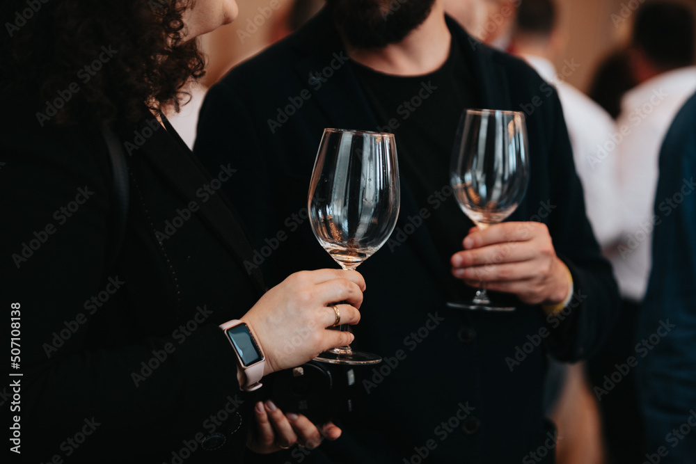 We celebrate success with a glass of rose wine in hand at a special tasting with happy people. We celebrate success with a glass of rose wine in hand at a special tasting with happy people.