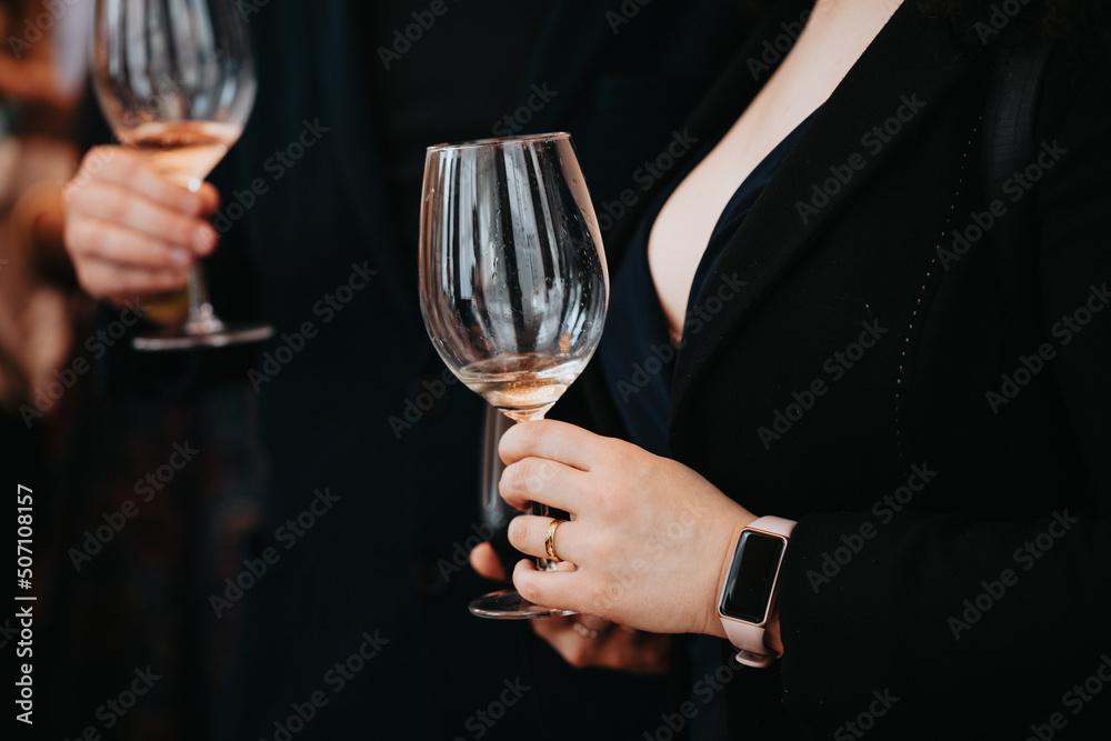 We celebrate success with a glass of white wine and champagne in hand at a special tasting with happy people. We celebrate success with a glass of white wine and champagne in hand at a special tasting with happy people.