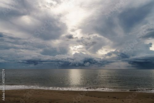 Rainstorms are forming under the clouds in the middle of the sea approaching the coast, a mysterious and fear natural phenomenon at Khao Lak Beach, Phang Nga, Thailand. Leave space for text input.