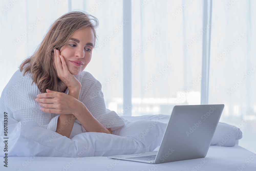 woman use computer notebook on bed look internet social network woman use computer notebook on bed look internet social network