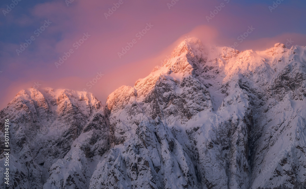 Sunrise in the mountains covered with fresh snow