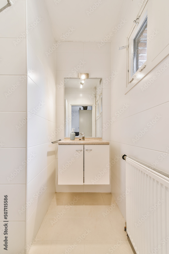 Interior of narrow bathroom at home Interior of narrow bathroom at home