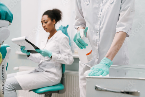 Multiracial two dentists working in dental clinic