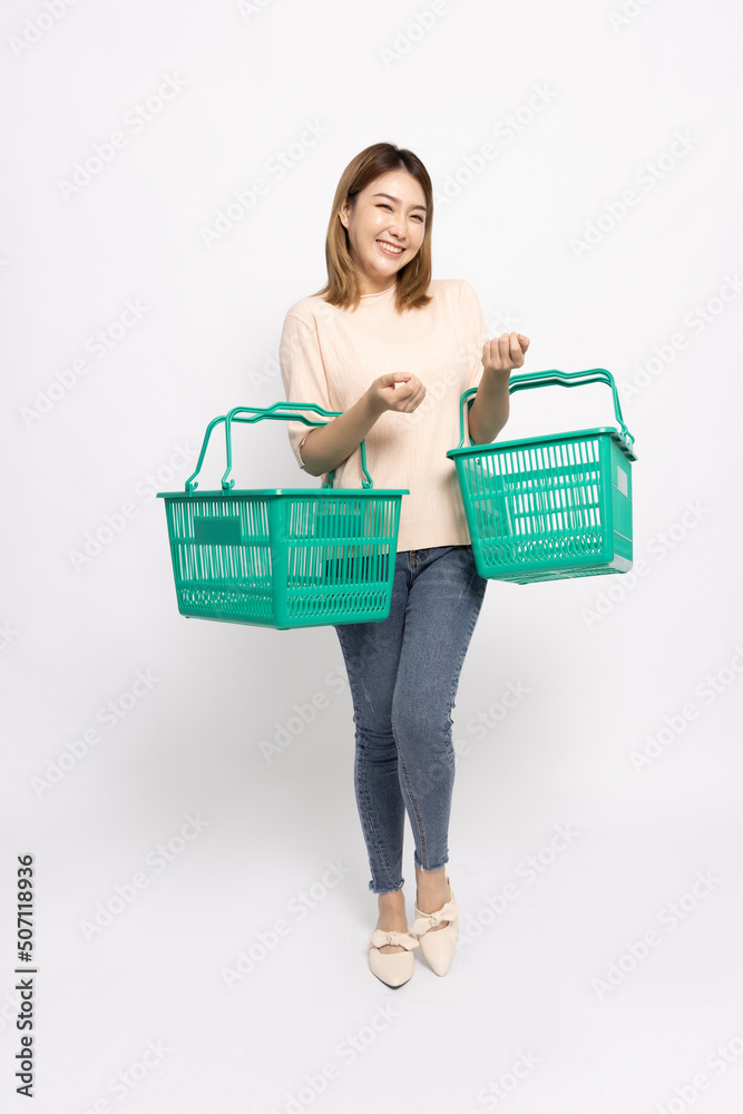 Asian woman smiling and holding green grocery basket isolated on white background, Shopping and Supermarket concept, Full body composition Asian woman smiling and holding green grocery basket isolated on white background, Shopping and Supermarket concept, Full body composition