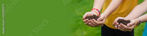 The child holds the soil in his hands. Selective focus. photo