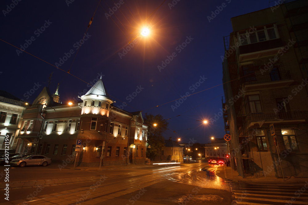Moscow, Russia - July, 27 2014: Historical buildings in Moscow center at night. Mansion on Yauza boulevard. Tram rails and light traces on foreground.