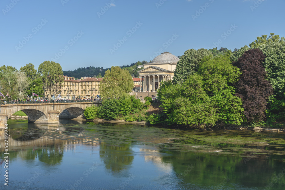 View from a bank of the Po river of the Vittorio Emauele I Bridge and the Church of the Gran Madre di Dio. Turin, Italy. May 1, 2022. View from a bank of the Po river of the Vittorio Emauele I Bridge and the Church of the Gran Madre di Dio. Turin, Italy. May 1, 2022.