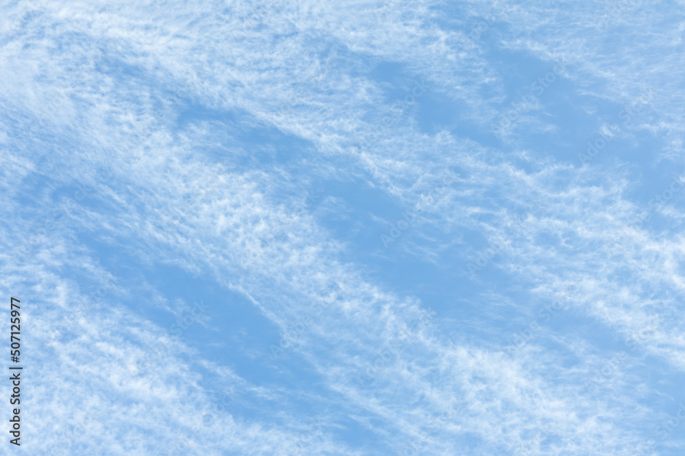 Cirrus Clouds. White cirrus clouds against the blue sky. Interesting background of blurry clouds.