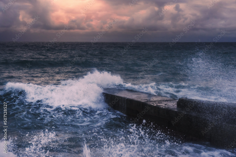 Storm at sea at sunset. Sea view with waves during rain and cloudy in Alupka. Crimea