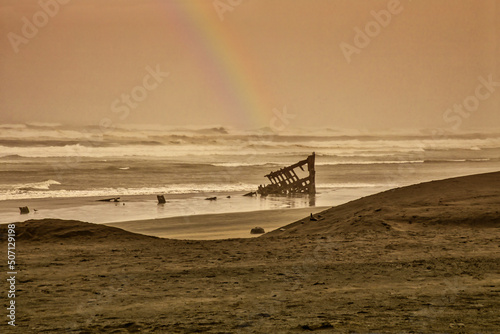 rainbow over shipwreck after terrible storm